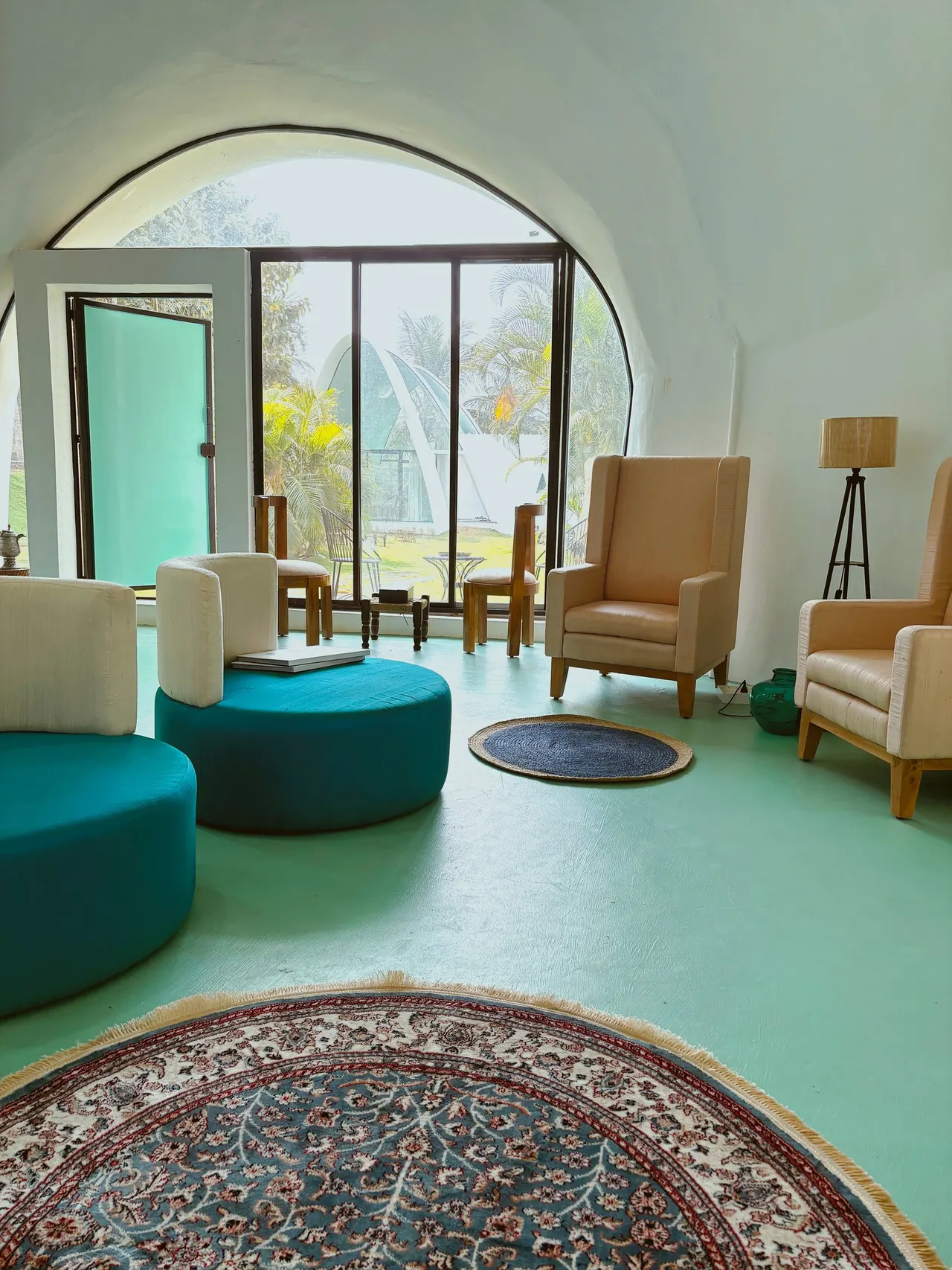 The lounge inside the Dome, with teal ottomans and armchairs