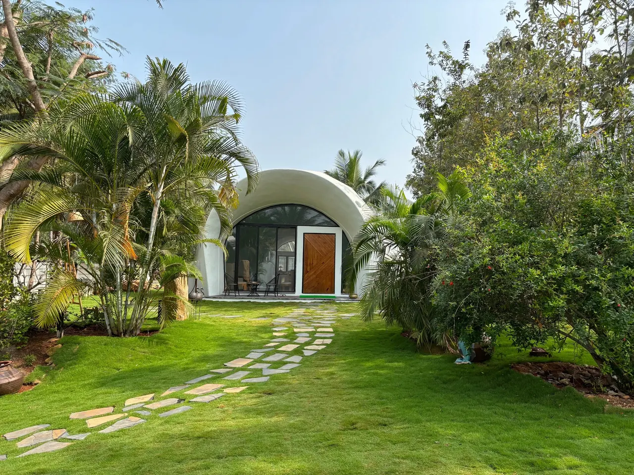 A stone path through the tropical garden to the Dome's entrance