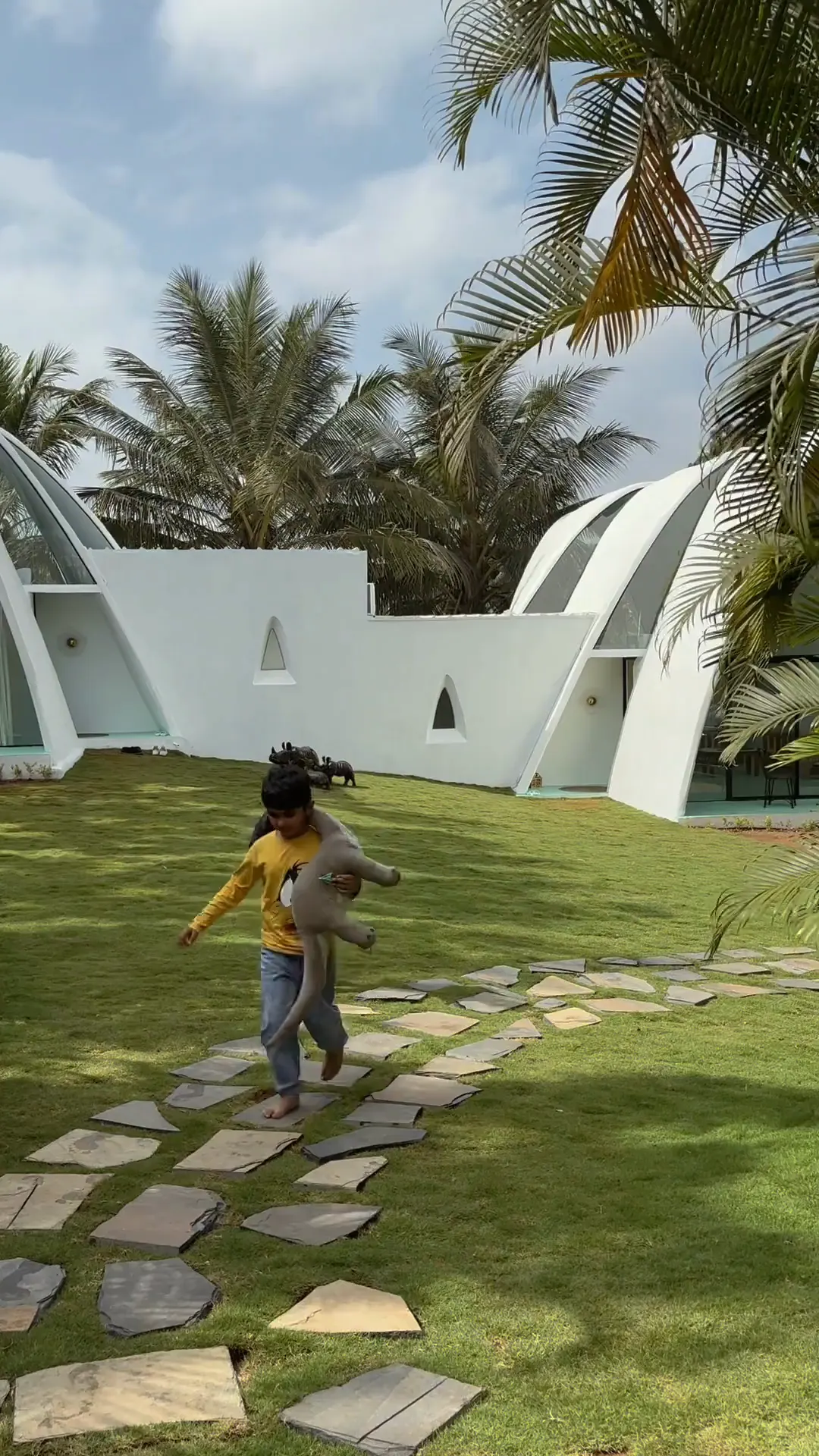 Children playing on the stepping-stone path across the lawn
