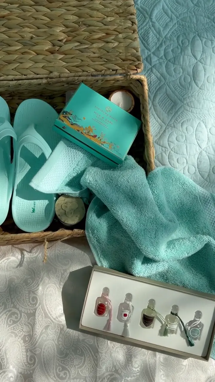 Spa towels, slippers and oils set out in a basket