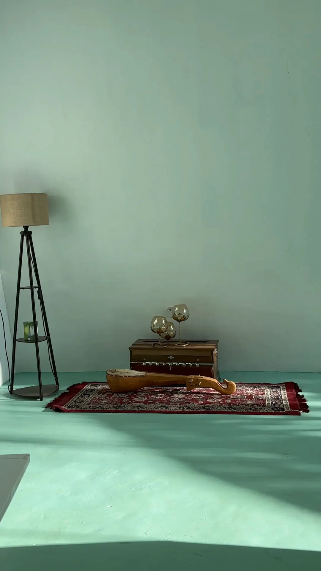 The spa therapy room, with a low table and rug on a mint floor